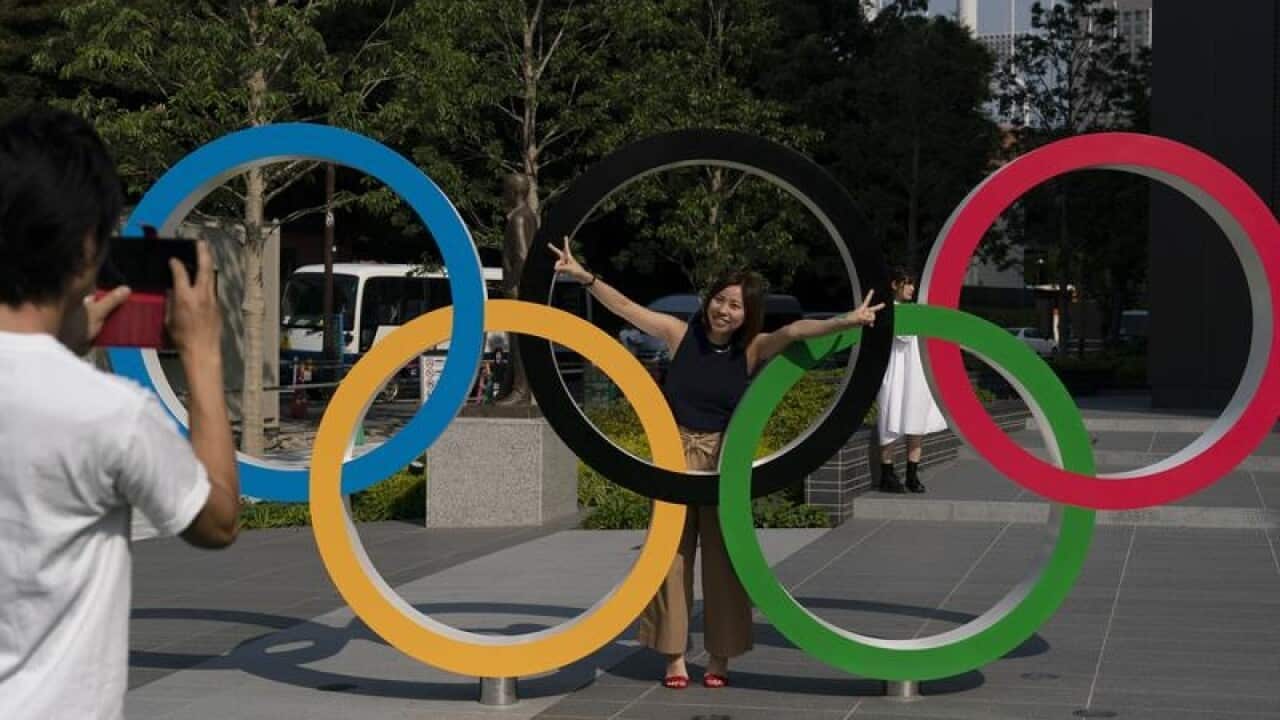 Tokyo residents Yuuma Sakai, takes photos of his wife, Hiroyo,