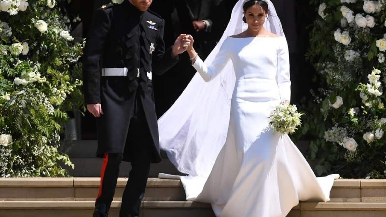 Prince Harry escorts his bride Meghan Markle from the chapel.
