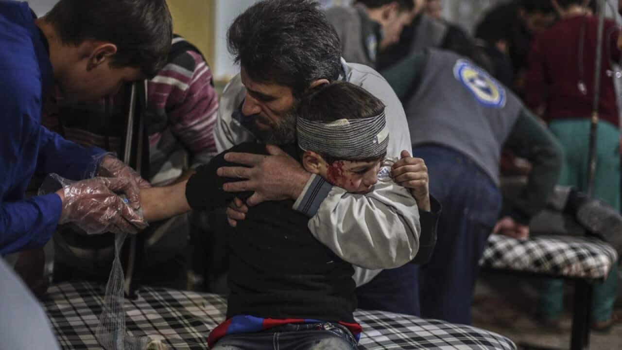 A Syrian boy receives first aid