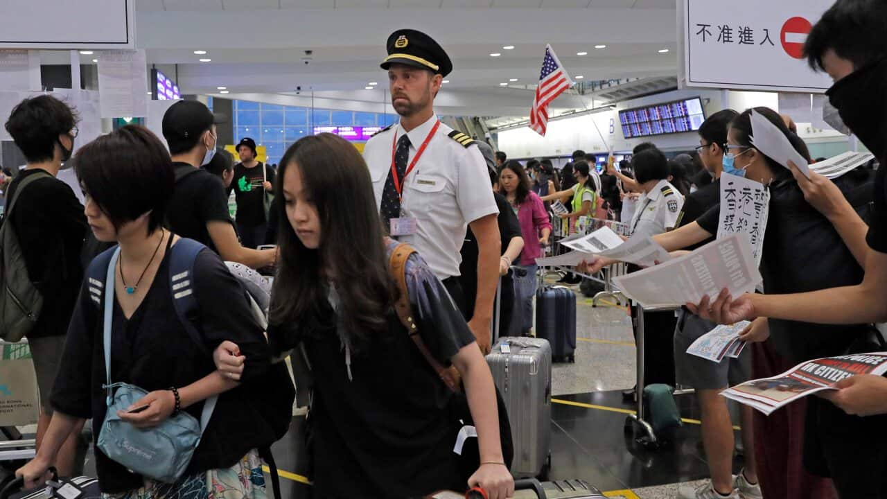 Passengers and flight crew at Hong Kong International Airport as protesters lock the arrival and departure halls down.