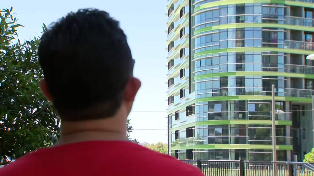 A resident looking at Opal Tower.