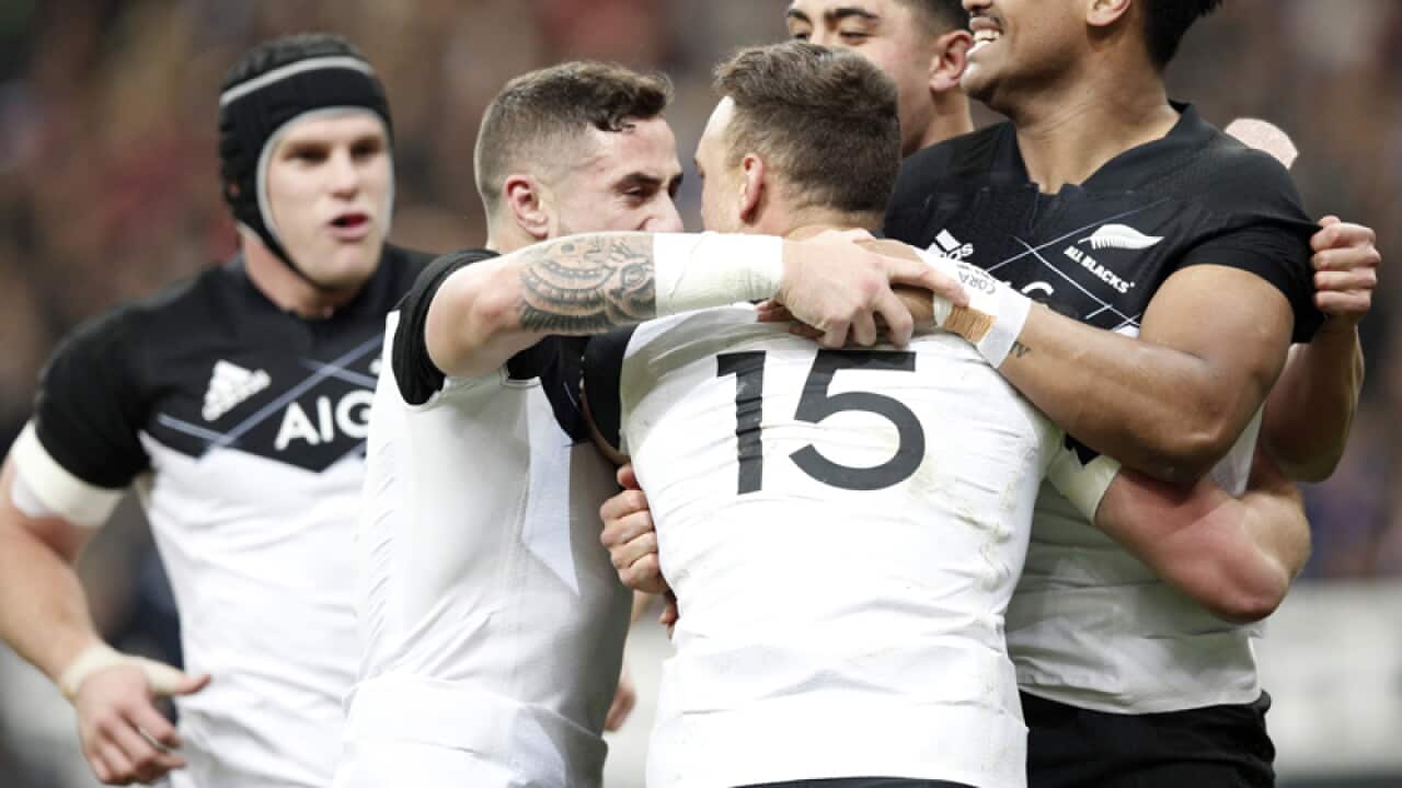 New Zealand's Israel Dagg, center, celebrates his try with teammates