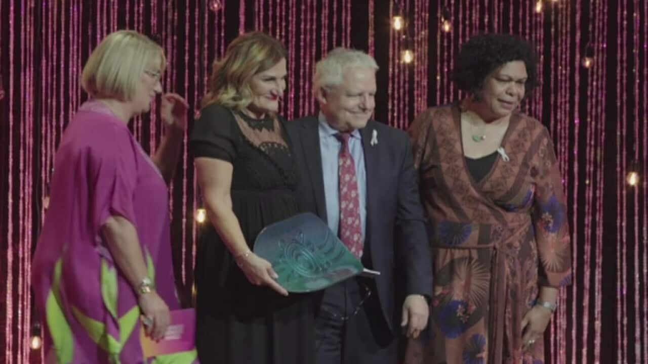 Violet Roumeliotis accepts her award