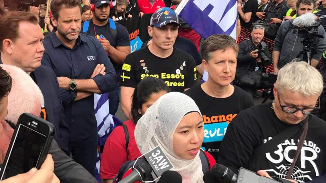 A member of the National Union of workers speaks at the rally about workers deserving a safe work space.