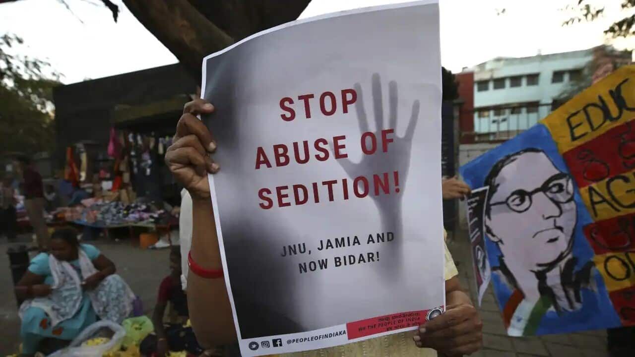 A woman holds a placard protesting against a sedition case filed by police in Bangalore, India.