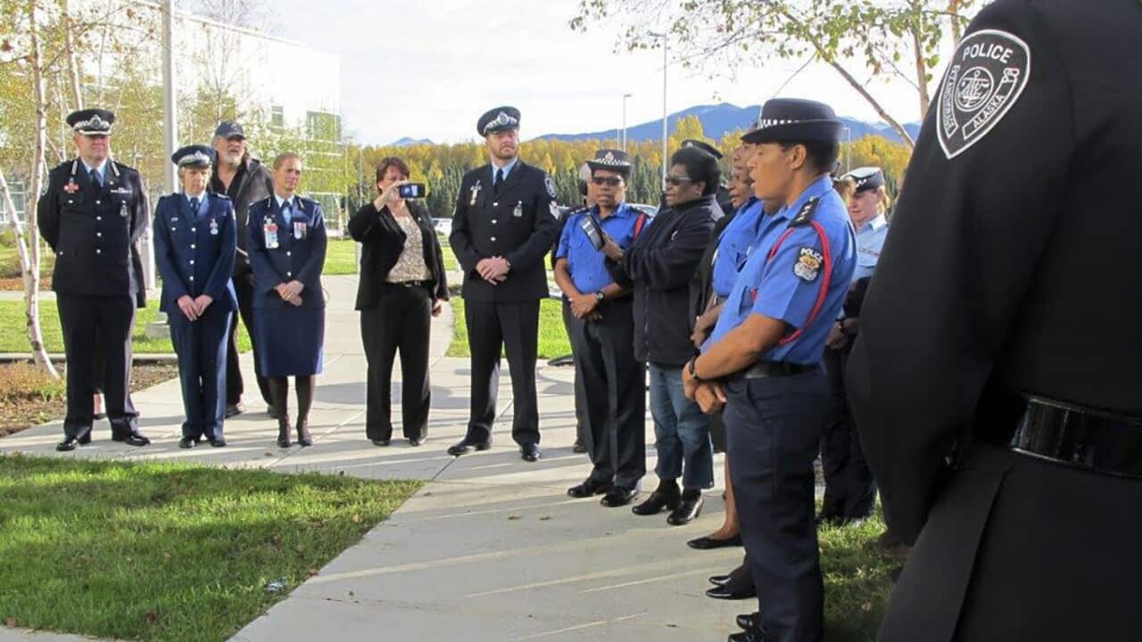Law enforcement representatives from Papua New Guinea sing a song during a police remembrance ceremony in Anchorage, Alaska.