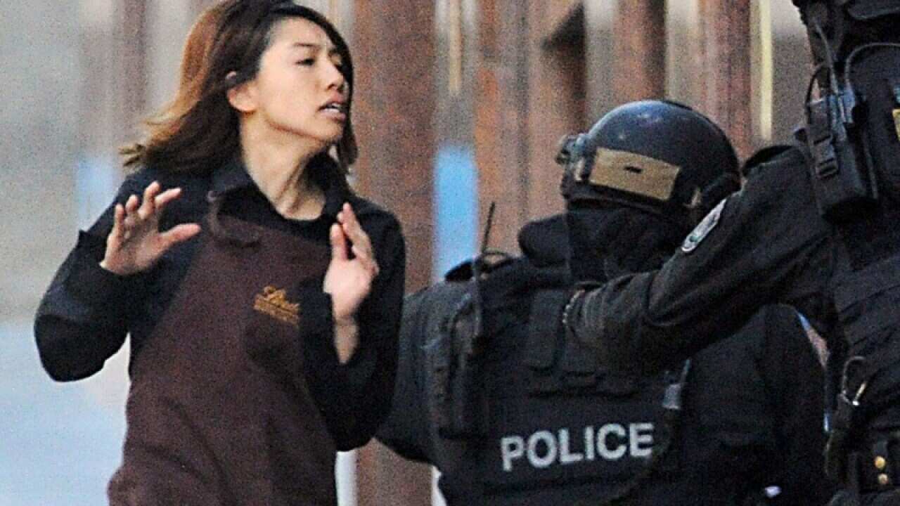 A hostage runs from the Lindt Chocolat cafe in Martin Place