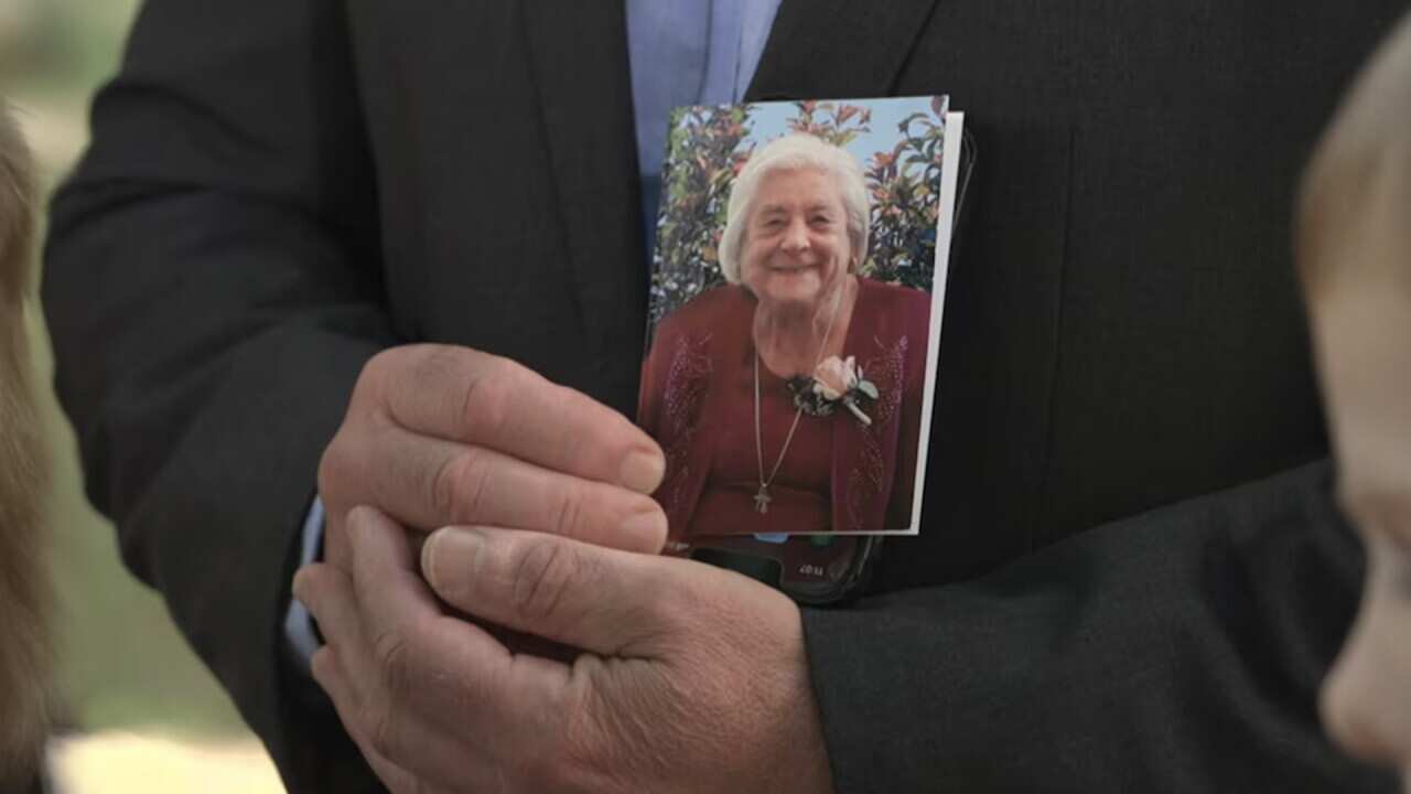 Vince Dimasi holding a photograph of his mother Maria Dimasi outside court house on Friday
