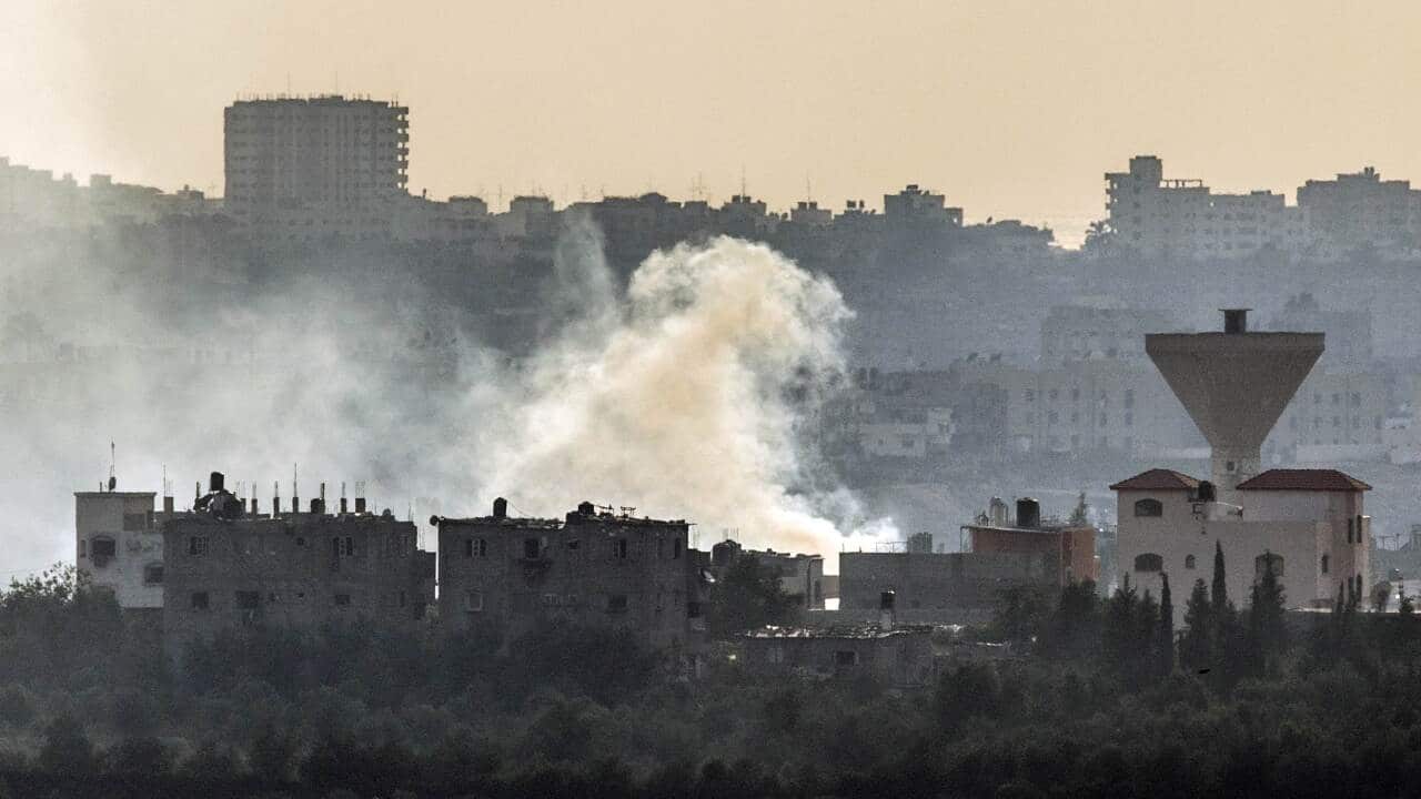 Southern Israeli-Gaza border shows smoke billowing from buildings following an Israeli air strike on Gaza City, on July 19, 2014 (AFP)
