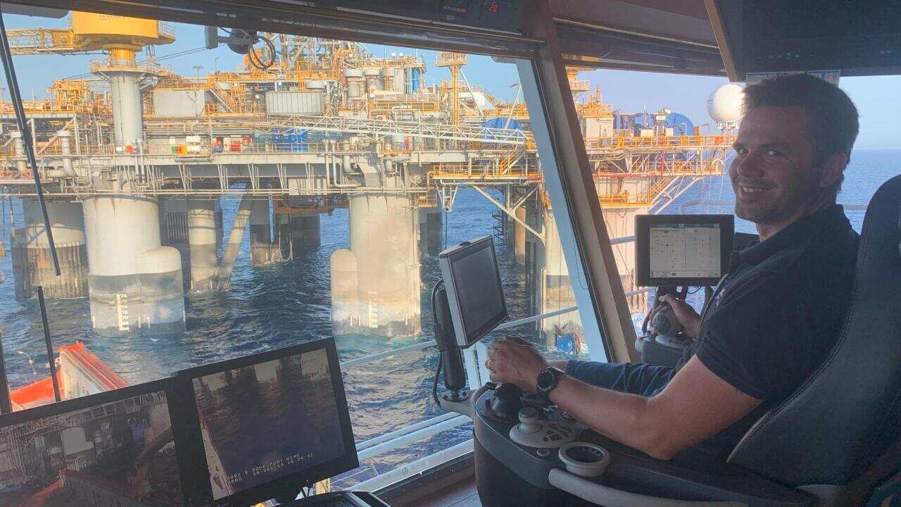 Ben Phillips at the helm of cargo ship the Normand Scorpion.