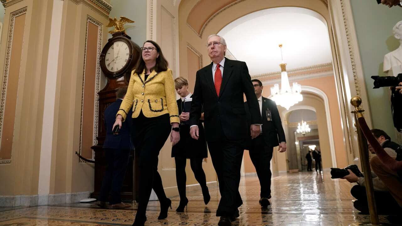 Senate Majority Leader Mitch McConnell walks to the Senate chamber