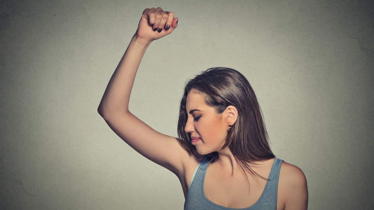 woman sniffing armpit