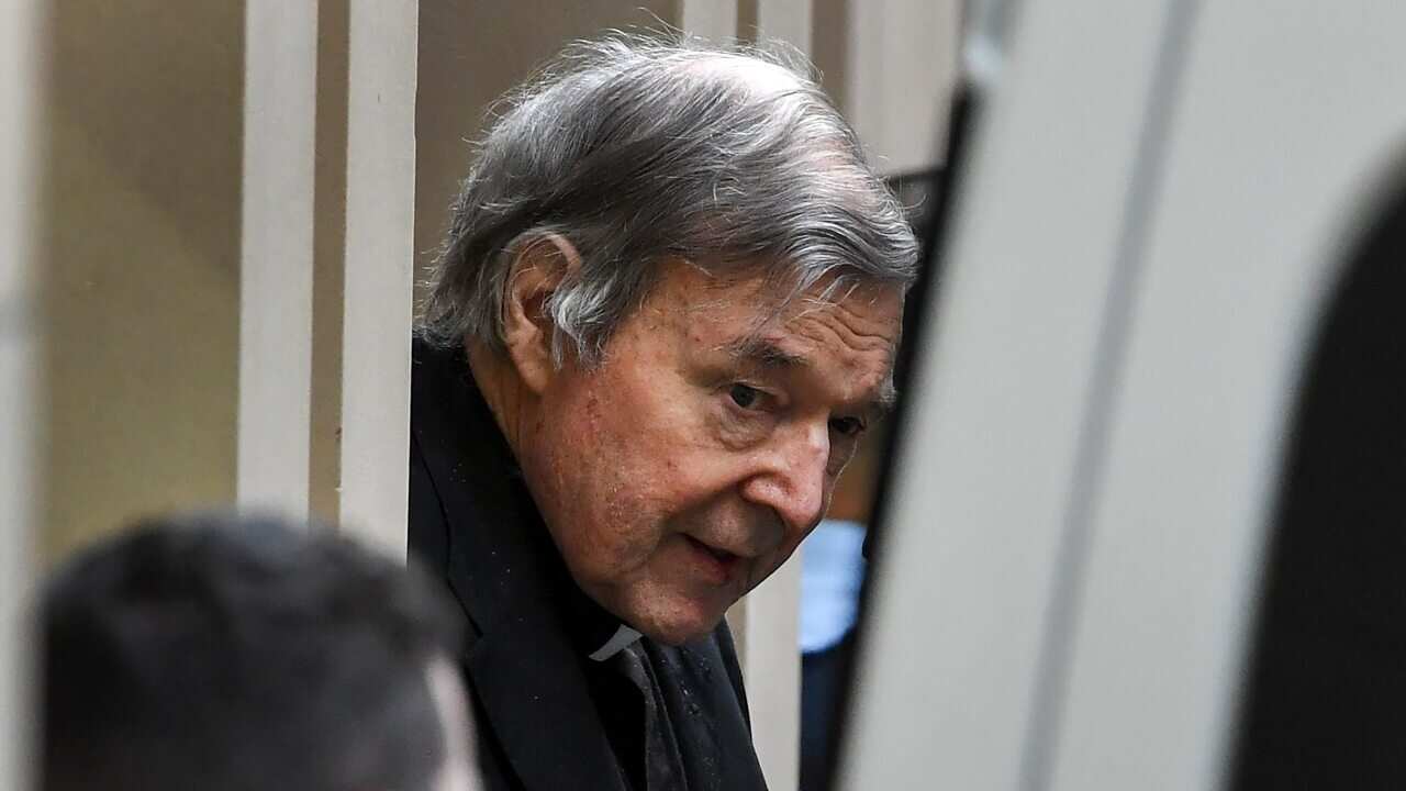 Australian Cardinal George Pell (C) is escorted in handcuffs from the Supreme Court of Victoria in Melbourne.
