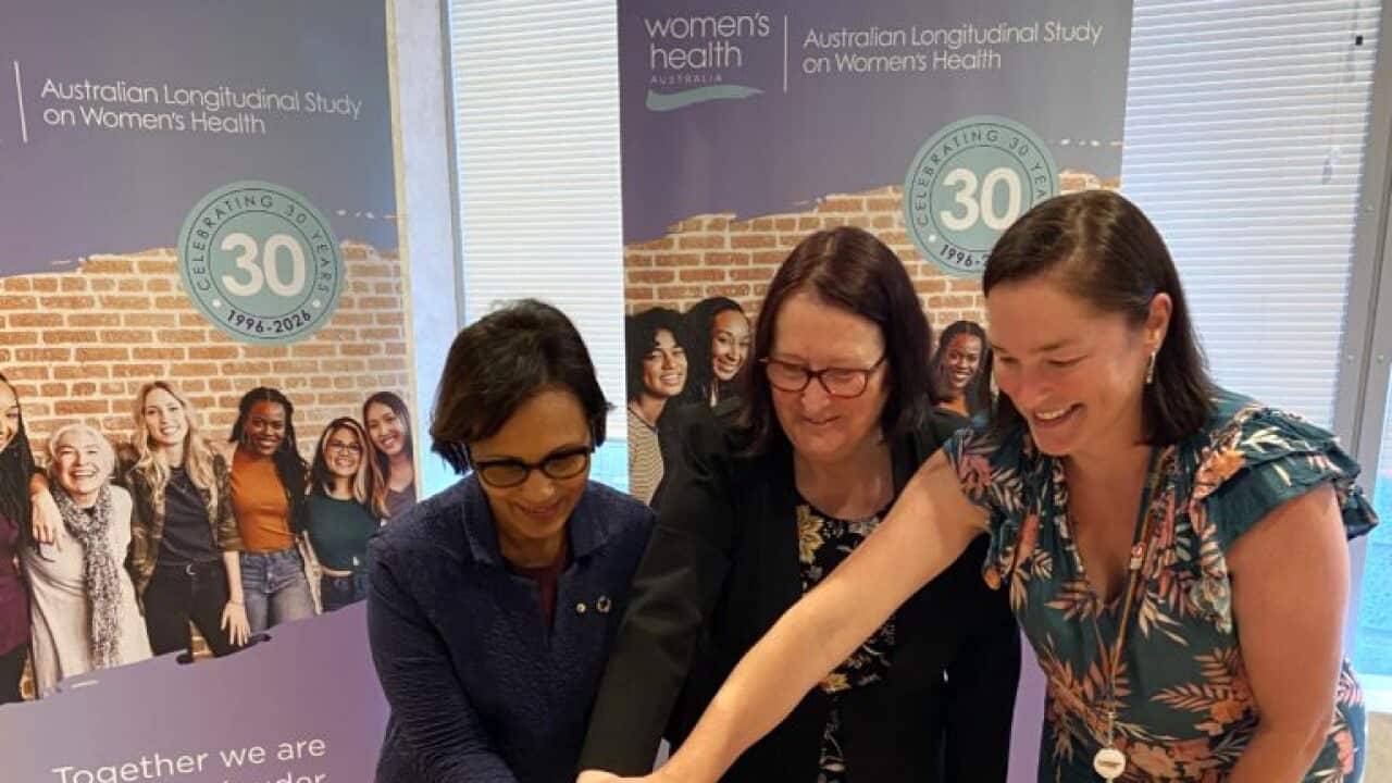 Researchers from the ALSWH cutting a cake to mark 30 years of their research into women's health