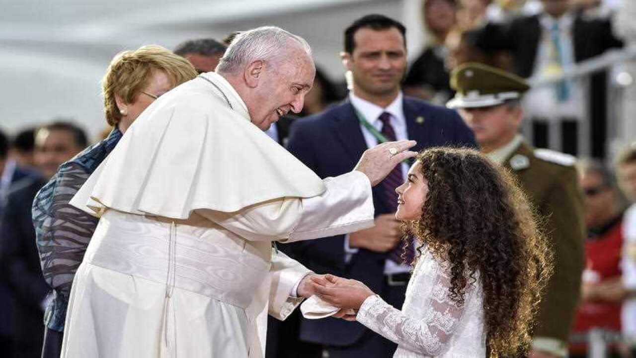 Pope Francis blesses a child