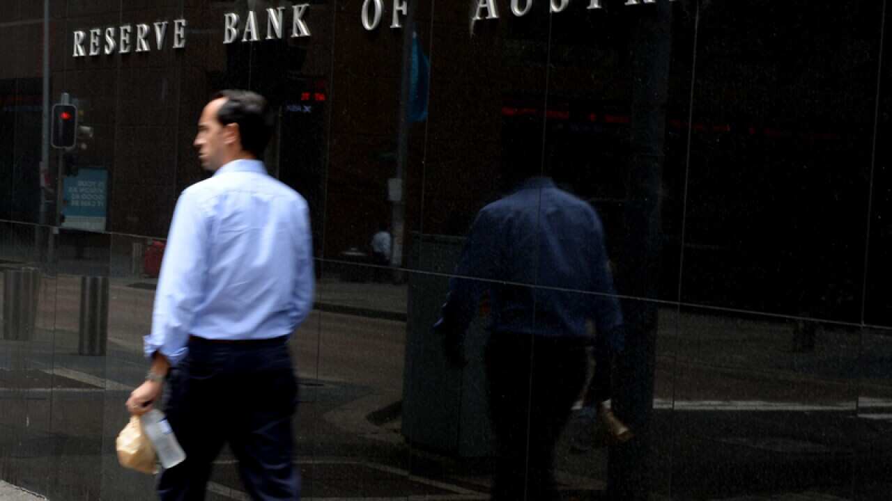 File photo of the a man walking past the RBA in Sydney