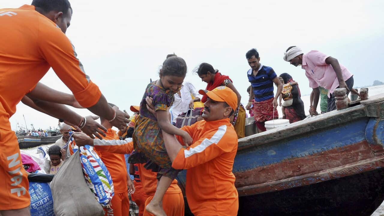 Rescuers of India's National Disaster Response Force shift flood affected people to safety at Nakta Diyara in Patna district, Bihar state, India