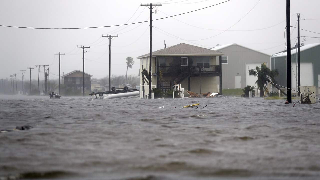 A home damaged by Hurricane Harvey remains surrounded by flood waters, Saturday, Aug. 26, 2017, in Rockport, Texas.