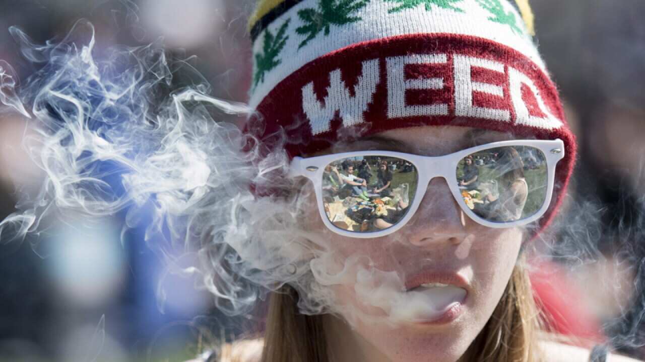 A woman smokes marijuana during a rally in Ottawa