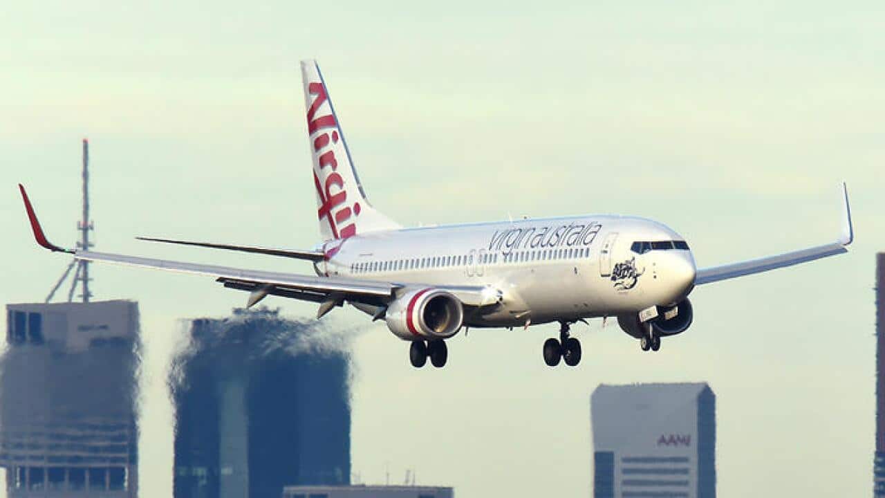 A Virgin Australia plane is seen on approach into Brisbane airport, Wednesday, May 4, 2016. (AAP Image/Dave Hunt) NO ARCHIVING