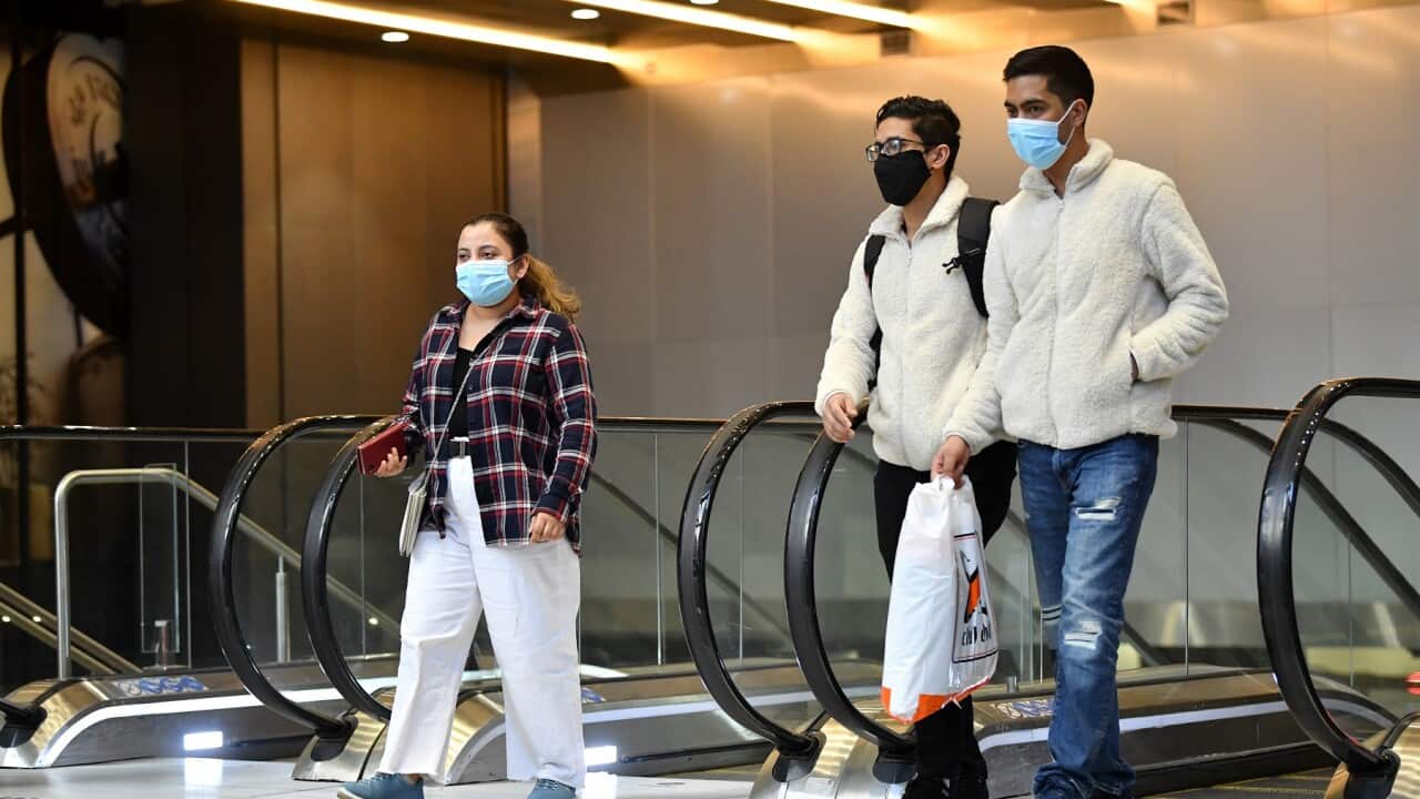 Commuters wearing face masks leave Wynyard Station in Sydney