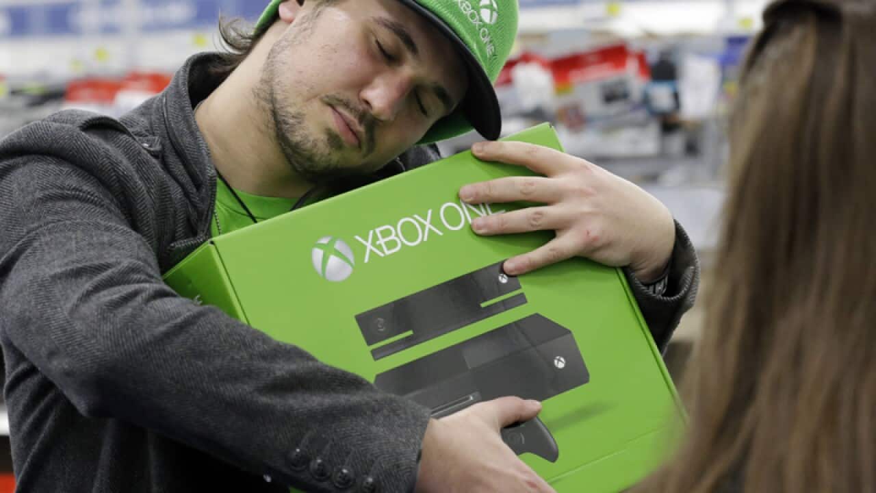 A man hugs his new Xbox One in Evanston