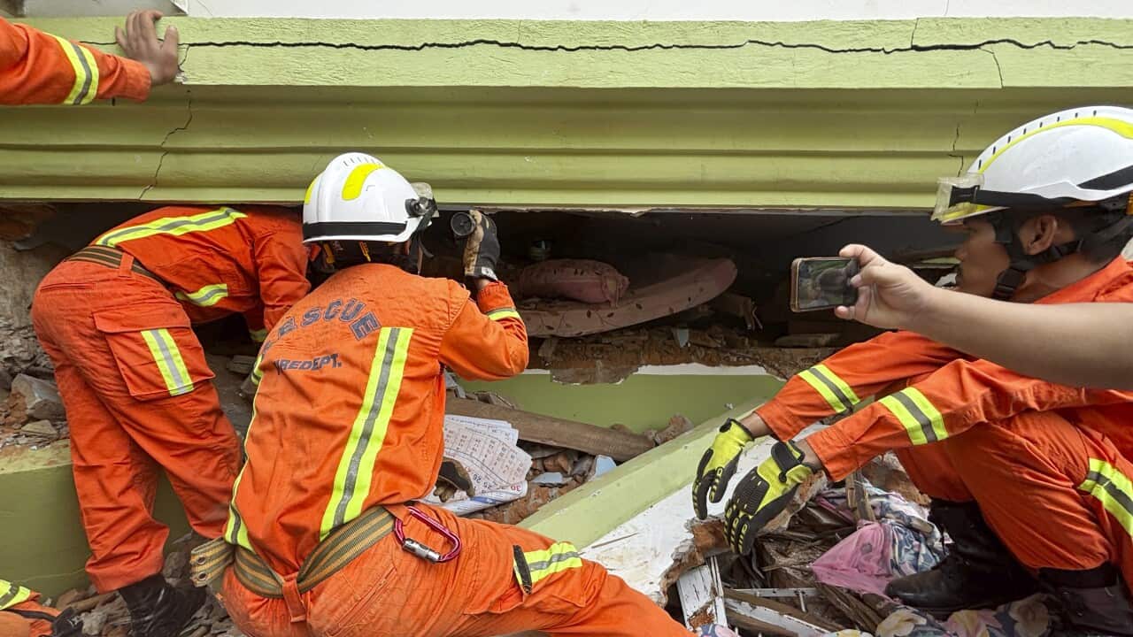 Rescue crews searching for survivors in the rubble of a building