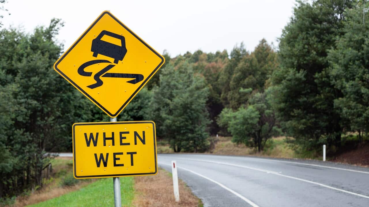 Road slippery when wet sign. Tasmania. Australia.