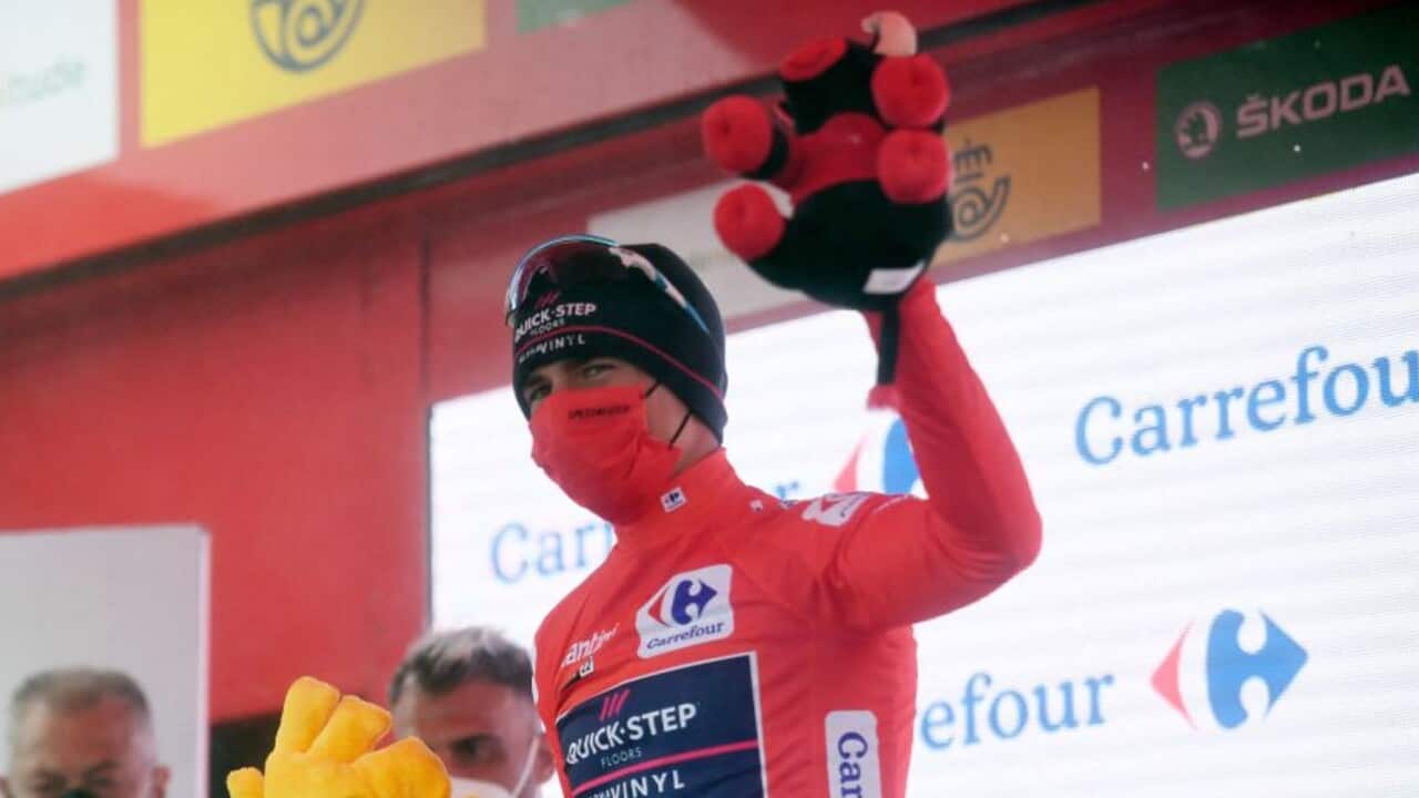 Remco Evenepoel celebrates in the red jersey