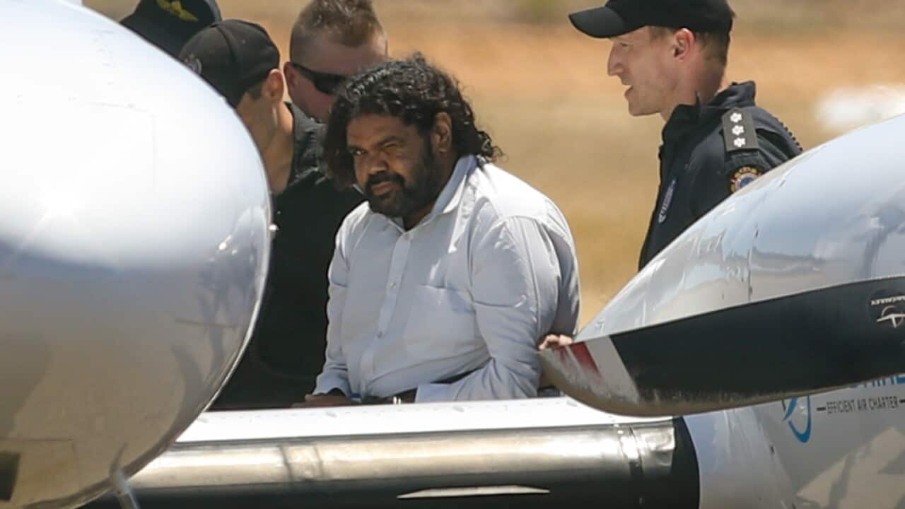 Cleo Smith's abductor being led across the tarmac to a plane after his arrest