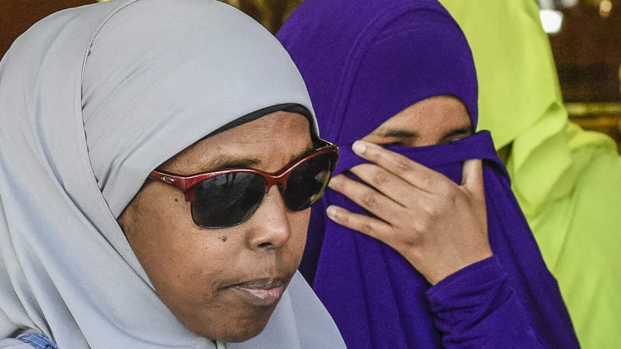 Zainab Abdirahman Khalif (centre) leaves the Supreme Court in Adelaide.