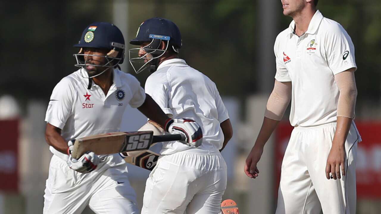 India's Cheteshwar Pujara and Wriddhiman Saha score runs