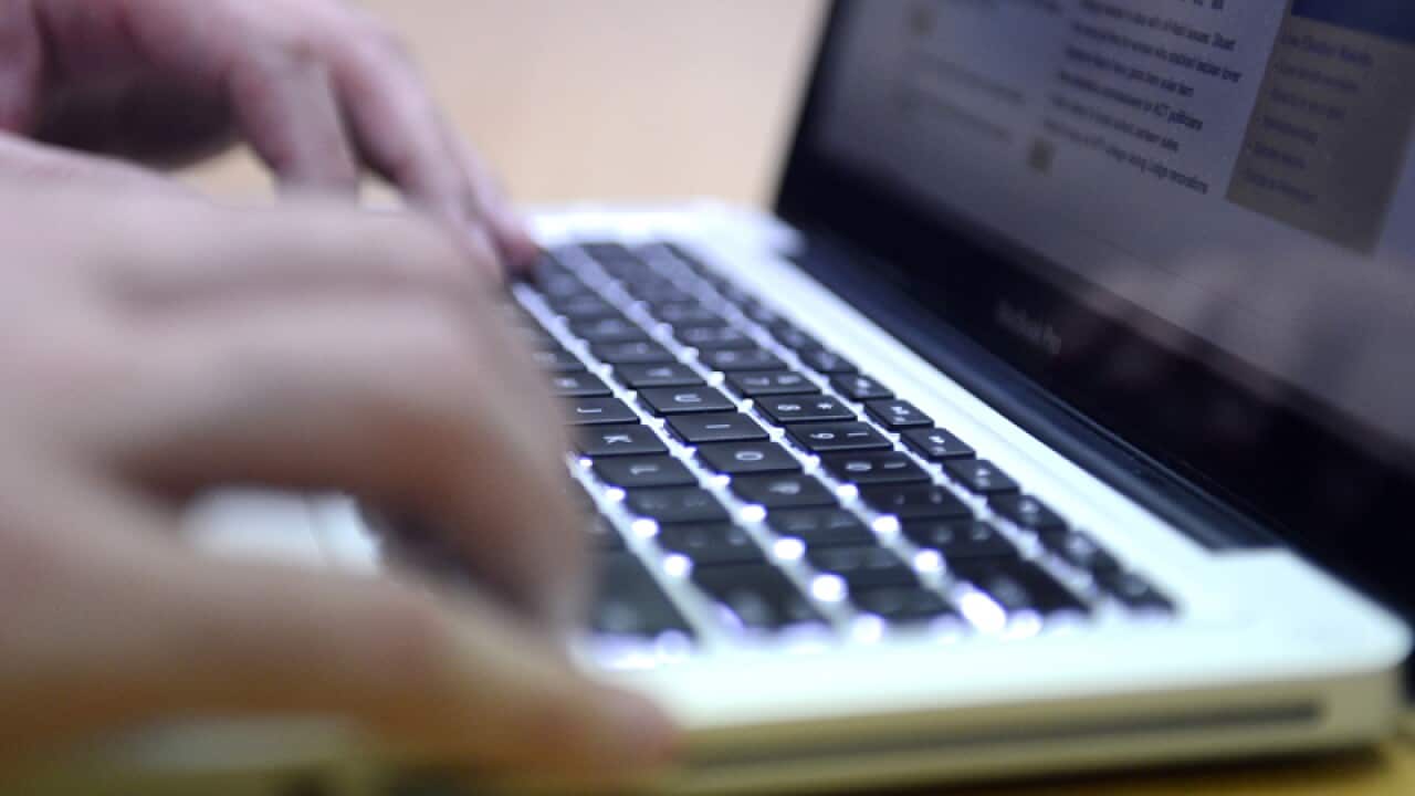 A man uses a laptop computer