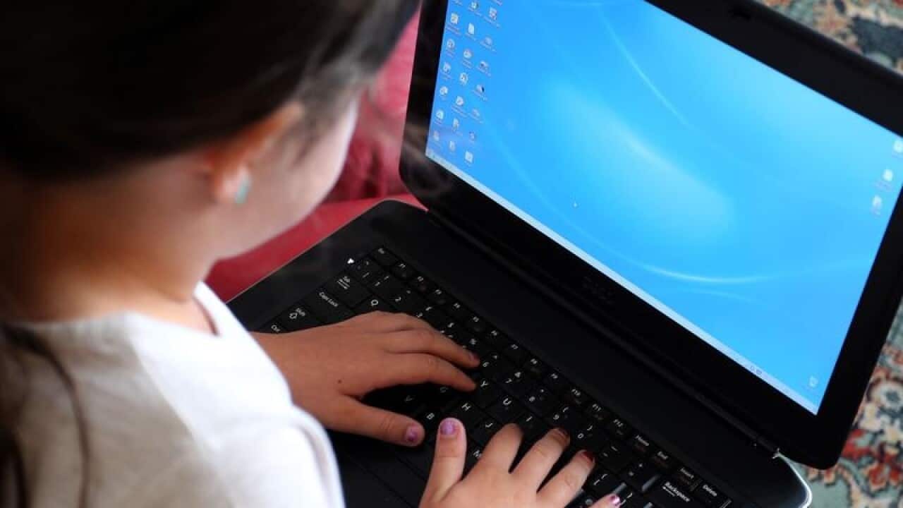 A child using a laptop computer.