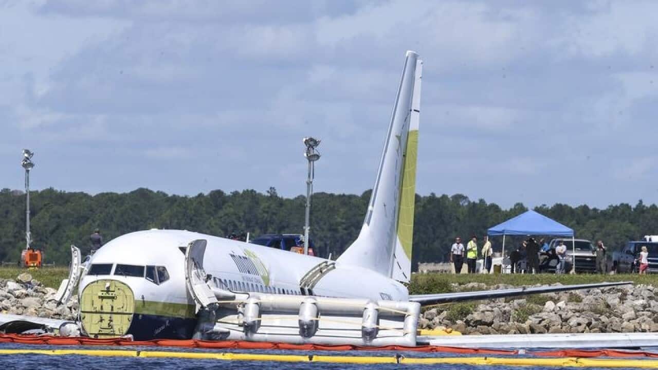 The plane is half submerged in the Florida river
