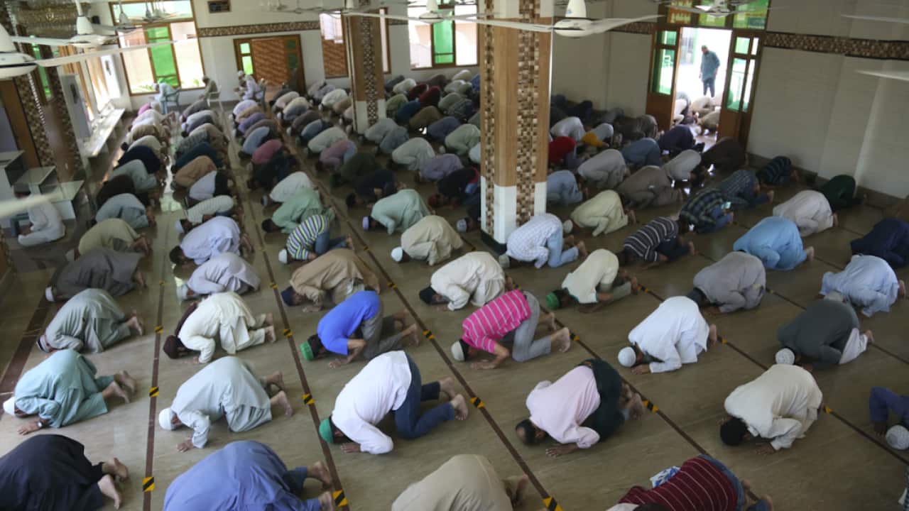 People attend evening prayers while maintaining a level of social distancing to help avoid the spread of the coronavirus, at a mosque in Karachi, Pakistan.