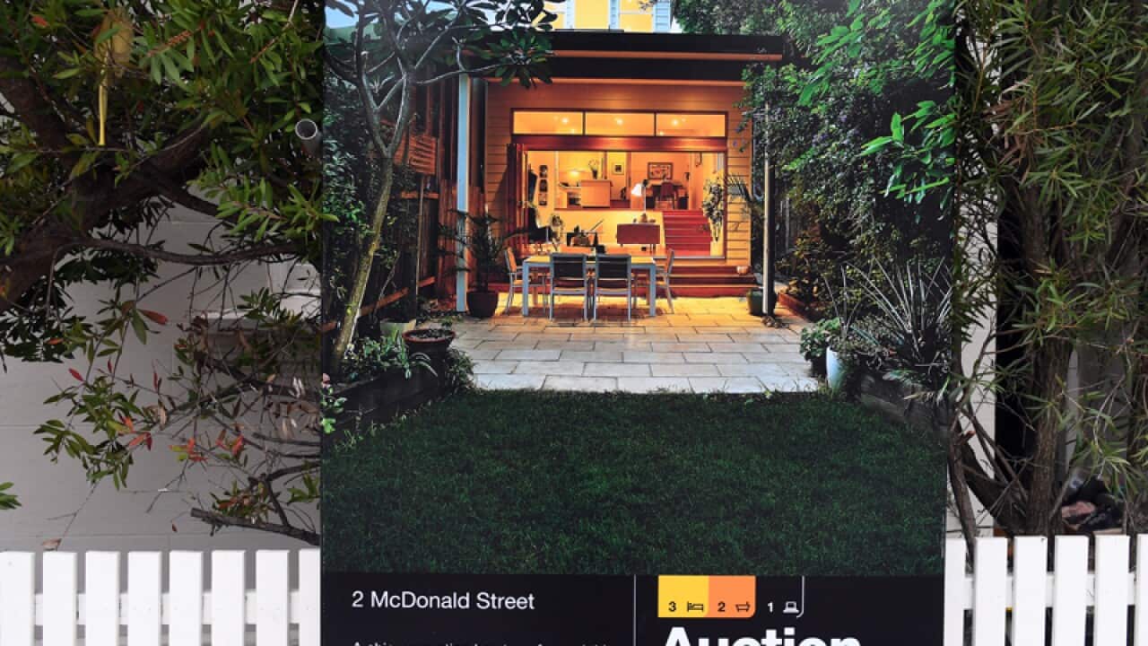 A for sale sign is displayed in front of a house in Sydney