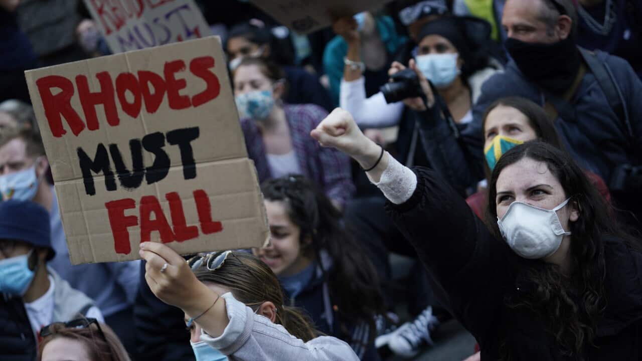 Protesters gather in front of Oriel College demanding the Cecil Rhodes statue be removed.