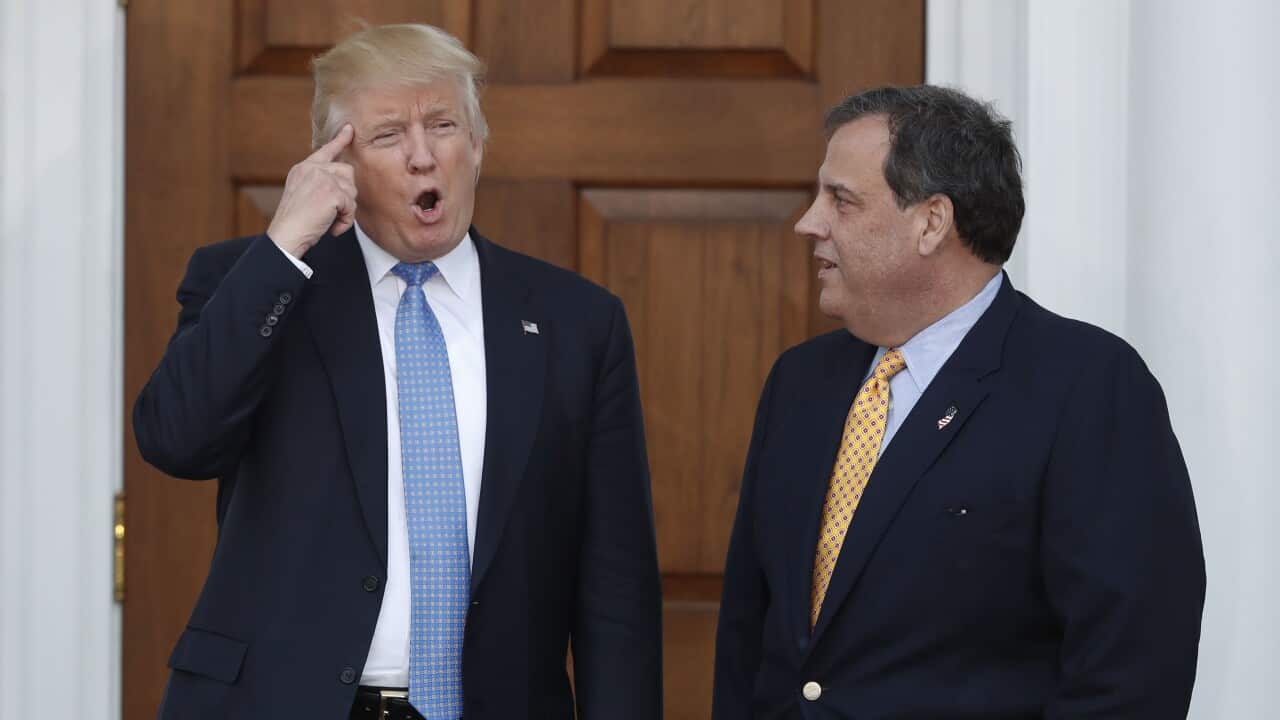 Donald Trump, left, gestures as Chris Christie looks on at the Trump National Golf Club Bedminster club, Sunday, Nov. 20, 2016.