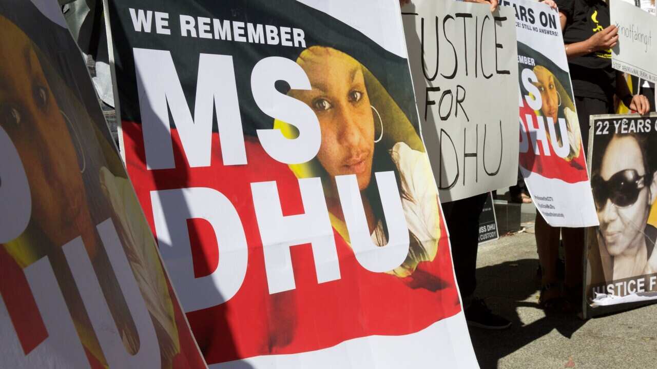 Crowd with Ms Dhu posters