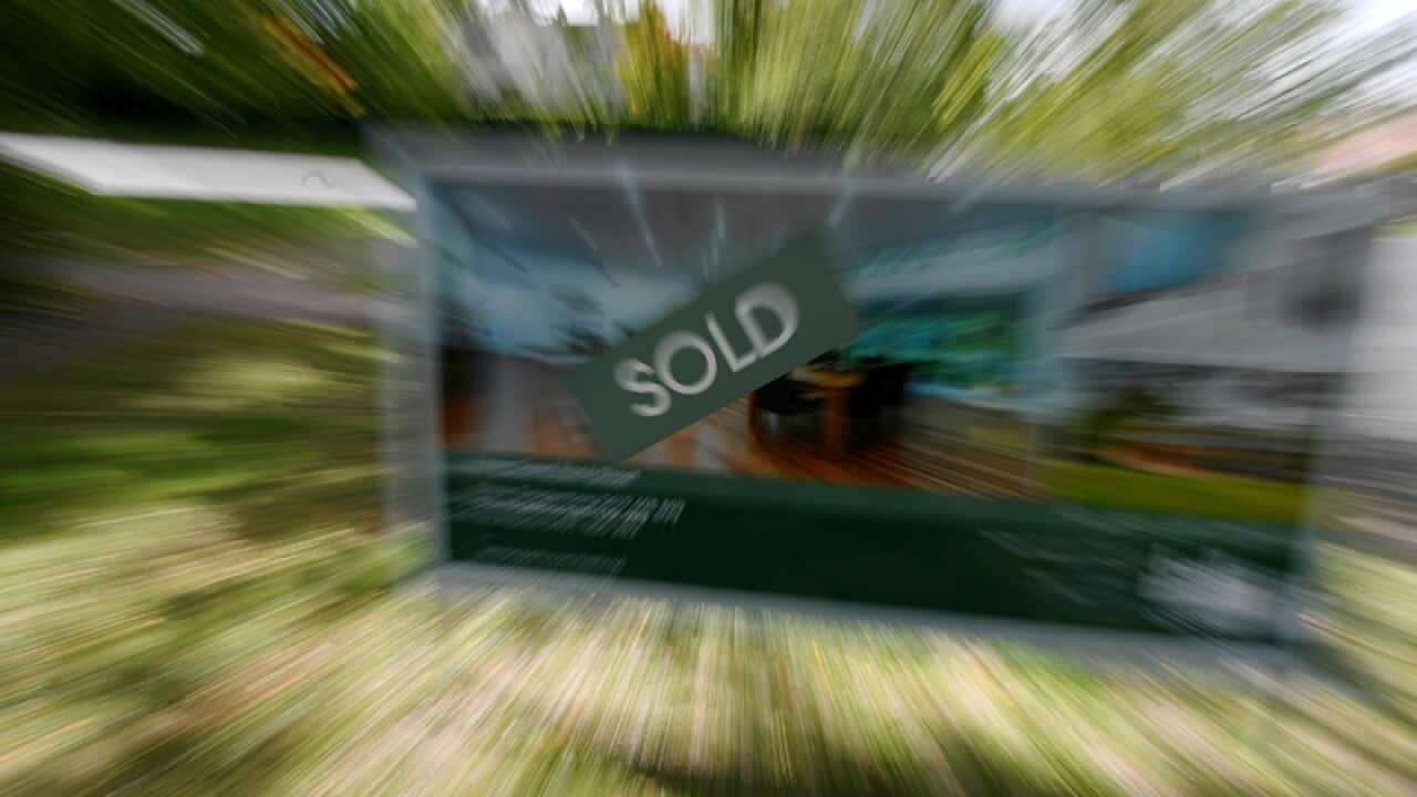 A real estate advertising board with a Sold sign