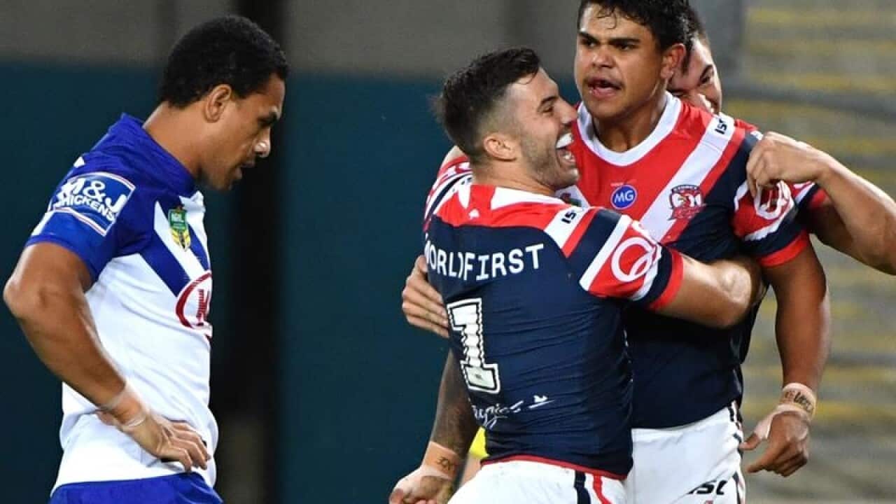 Roosters players celebrate with Latrell Mitchell.