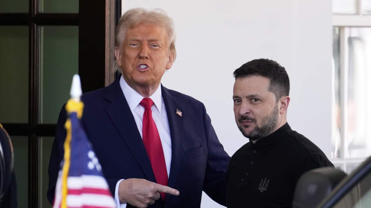 Donald Trump points his right index finger at Volodymyr Zelenskyy, who is standing beside him.