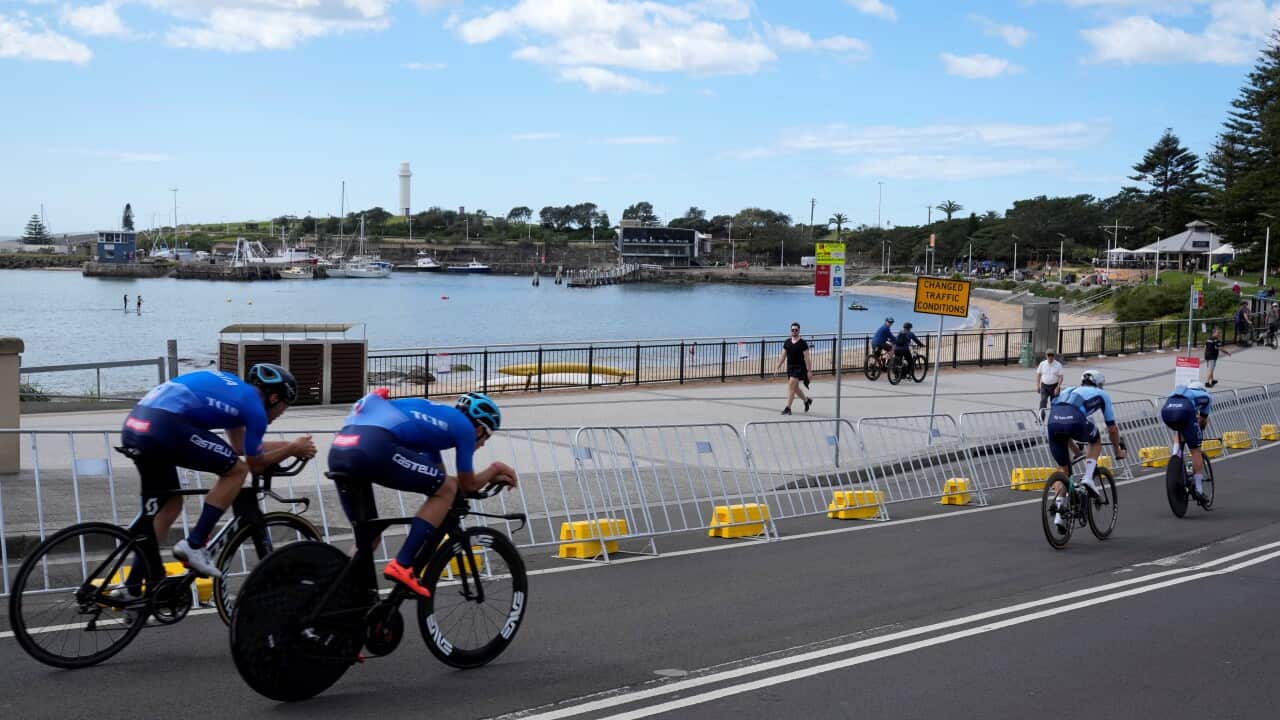 Cyclists ride along the beach in Wollongong, during the World road cycling championships in Australia in September 2022