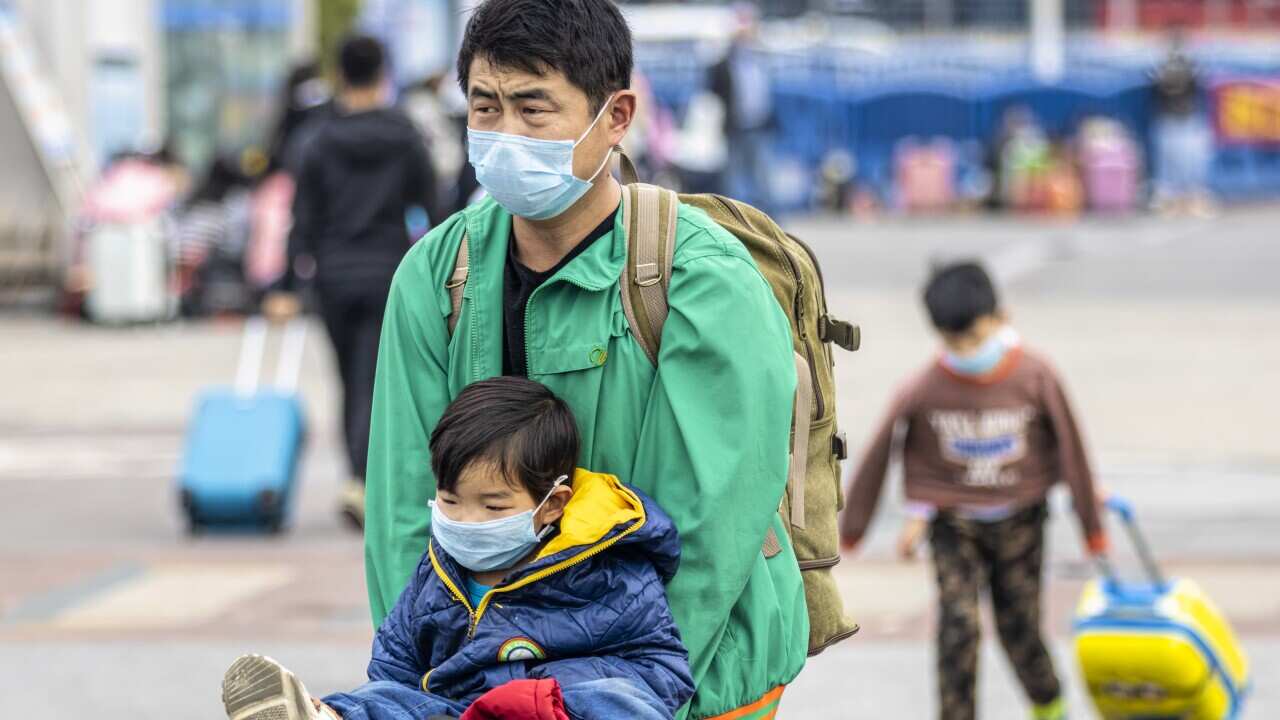 People at Guangzhou main railway station wearing protective masks.