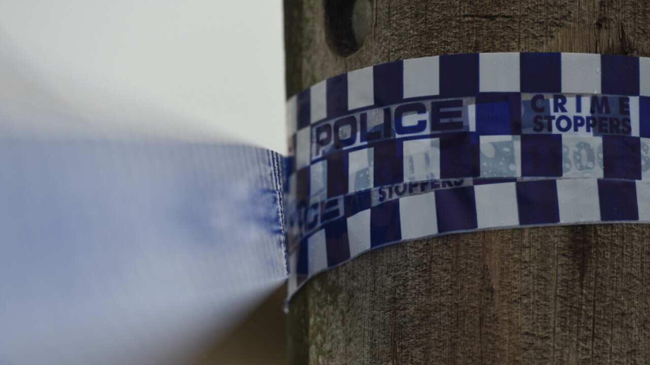 Police tape is seen at a home