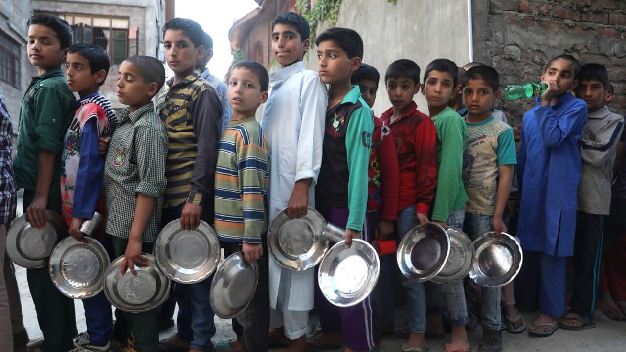 Kashmiri orphans queue for food