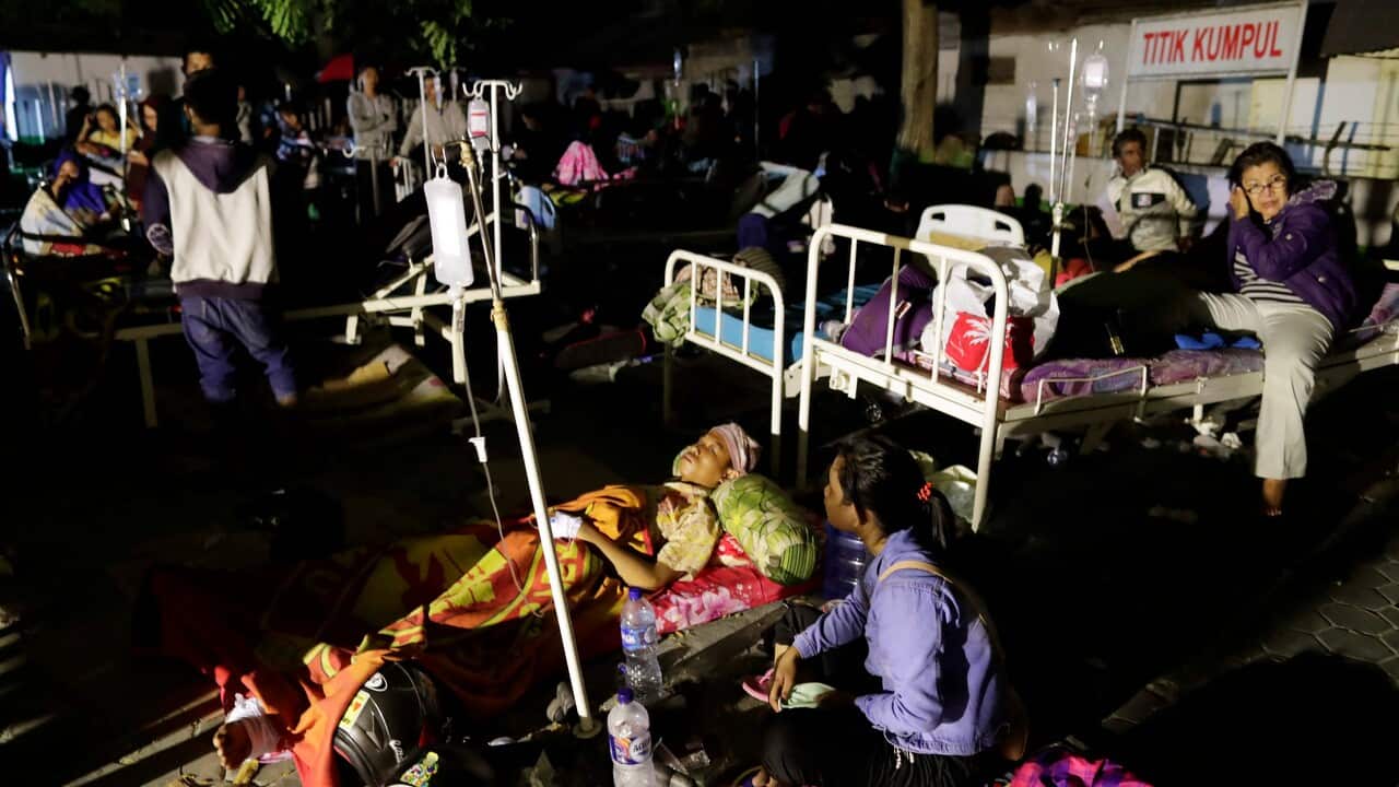 Indonesian earthquake and tsunami survivors receive medical treatment outside a military hospital in Palu, Central Sulawesi.