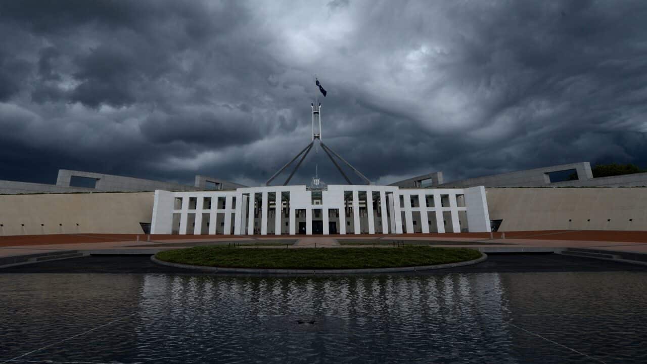 Storm clouds are seen building up over Parliament House in Canberra, Wednesday, Feb. 19, 2014. Canberra has been hit by strong rain and winds. (AAP Image/Lukas Coch) NO ARCHIVING