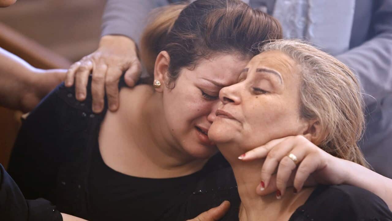 Relatives of killed Coptic Christians grieve during their funeral at Church of Great Martyr Prince Tadros, in Minya, Egypt.